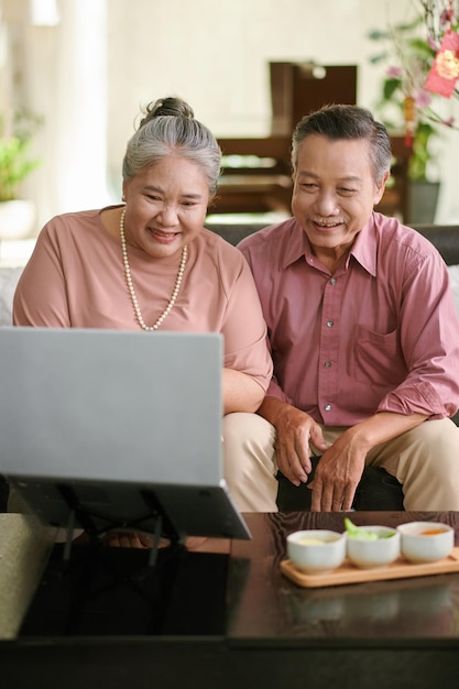 Senior couple videocalling family memeber on tet