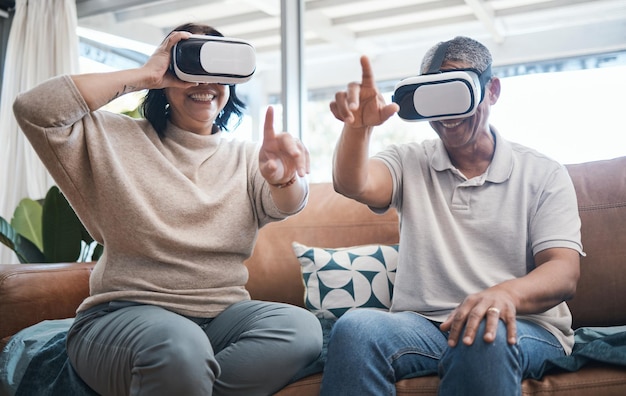 Senior couple virtual reality and sofa in home living room with esports metaverse or internet gaming with smile Man woman and vr with happiness learning and futuristic goggles on lounge couch