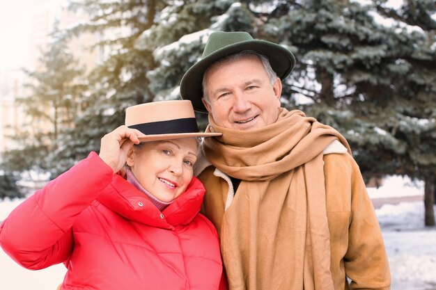 Senior couple in warm clothes outdoors. Winter vacation