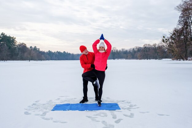 Senior couple warming before warms up and does stretching before workout