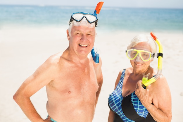 Senior couple wearing snorkel and diving goggles