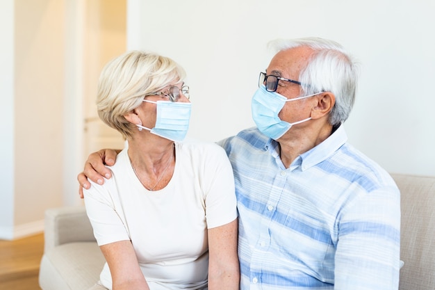 Senior couple with protective mask in quarantine at home