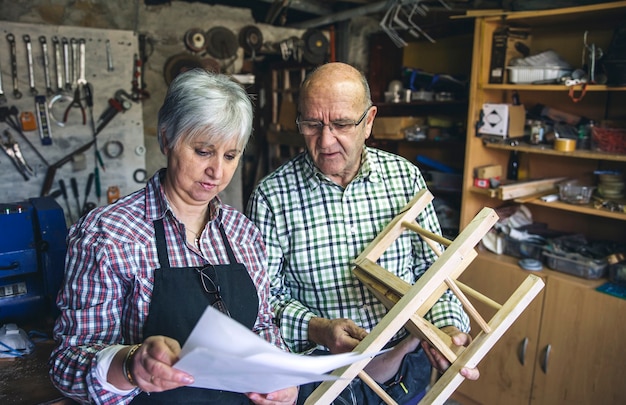 Senior couple working in a carpentry workshop