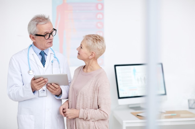 Senior doctor counseling patient