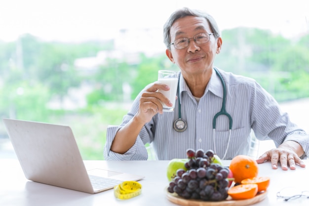 Senior doctor drink milk advisor eating healthy food for diet