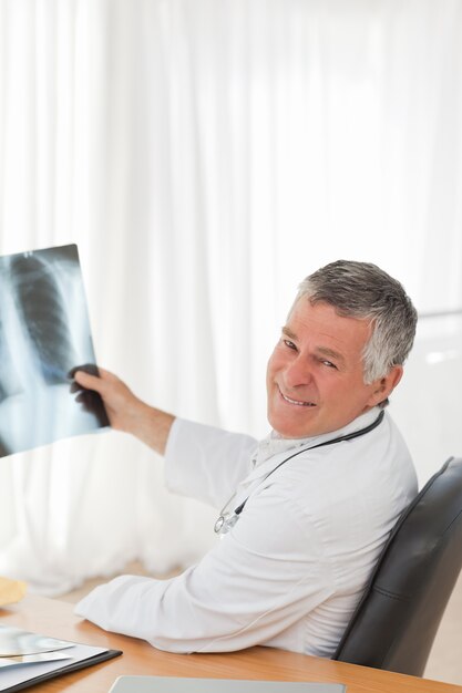 A senior doctor looking at the X-ray