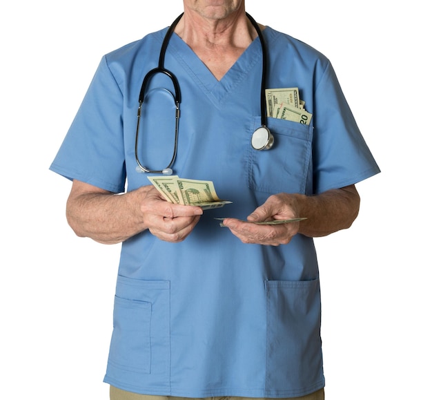 Senior doctor in scrubs counting cash