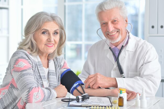 Senior doctor with a elderly patient in his office