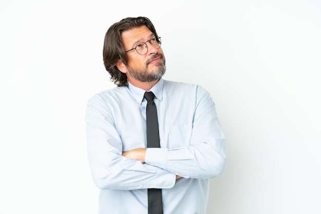 Senior dutch business man isolated on white background looking up while smiling