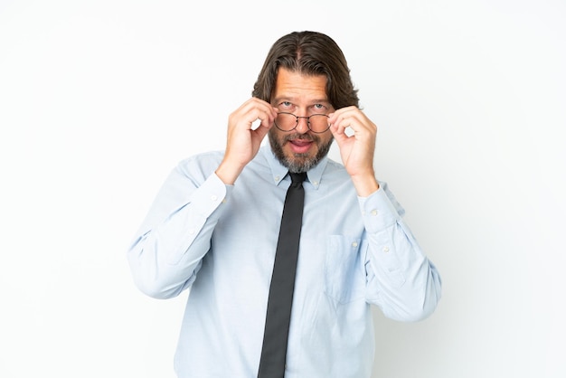 Senior dutch business man isolated on white background with glasses and surprised