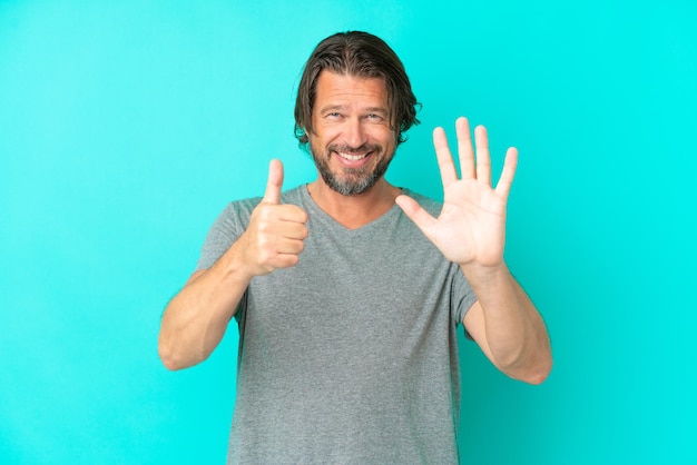 Senior dutch man isolated on blue background counting six with fingers