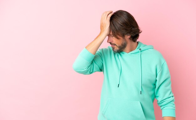 Senior dutch man isolated on pink background with headache