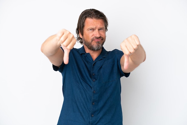 Senior dutch man isolated on white background showing thumb down with two hands