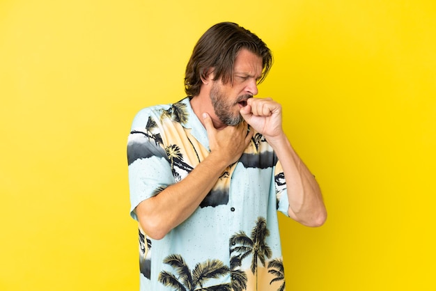 Photo senior dutch man isolated on yellow background coughing a lot