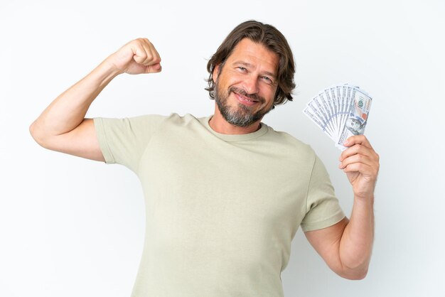 Senior dutch man taking a lot of money isolated on white background doing strong gesture