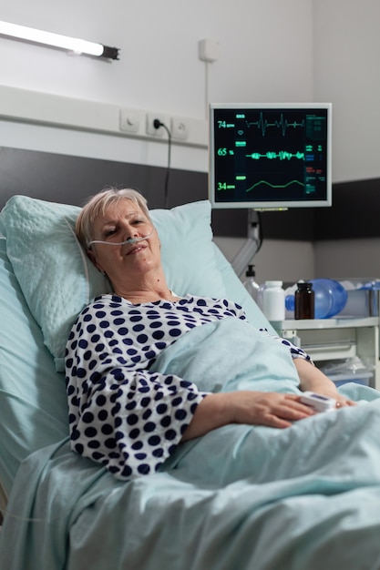 Senior elderly person with pulmonary failure breathing through oxygen mask