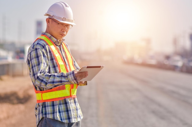 Senior Engineer Asian man working with tablet technology construction construction worker with tablet computer and wearing construction uniform