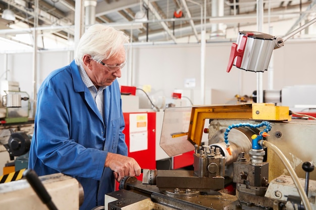 Senior engineer working in a factory close up