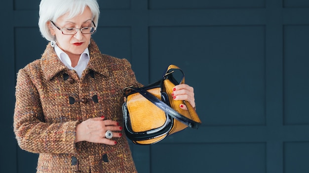 senior fashion stylist blogger. aged lady in trendy autumn outfit shooting vlog.