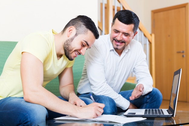 Senior father helping young son