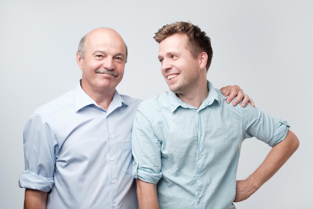 Senior father is proud of his mature son