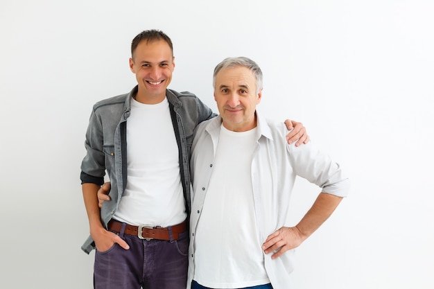 Senior Father With Adult Son on a white wall