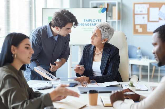 Senior female boss instructing employee