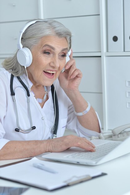 senior female doctor working at her cabinet