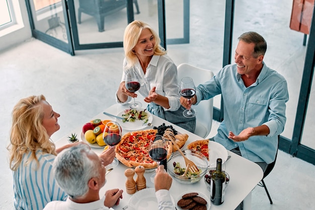 Senior friends having dinner at home