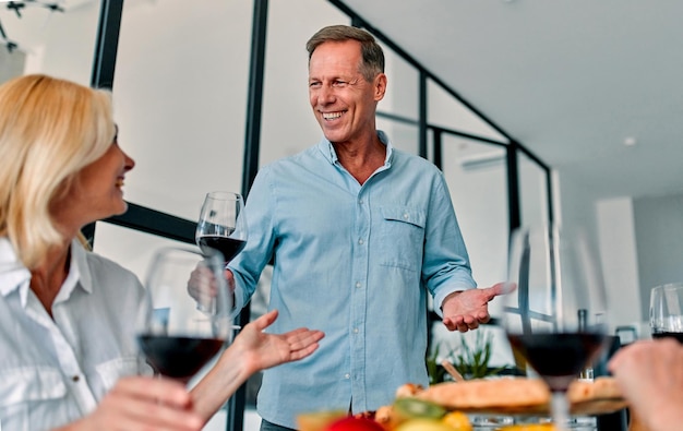 Senior friends having dinner at home