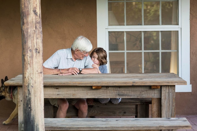 senior grandfather talking with his 5 year old grandson