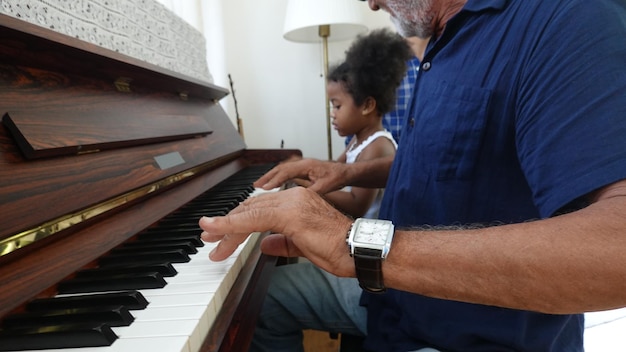 Senior grandparents playing with grandchildren and having fun with family