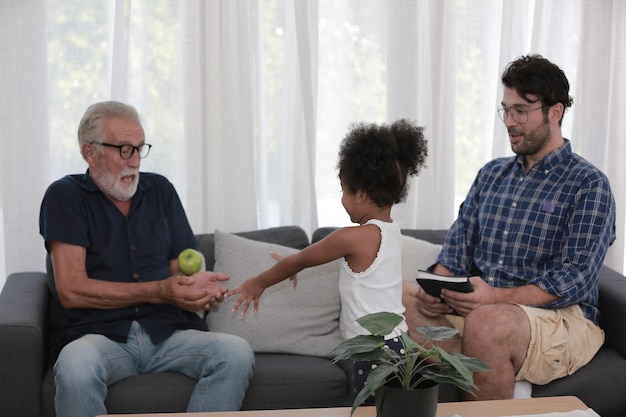 Senior grandparents playing with grandchildren and having fun with family