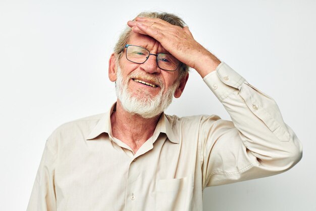 Senior greyhaired man smile emotion hand gesture light background