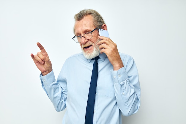 Senior greyhaired man talking on the phone business work isolated background