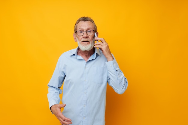 Senior greyhaired man talking on the phone emotions isolated background