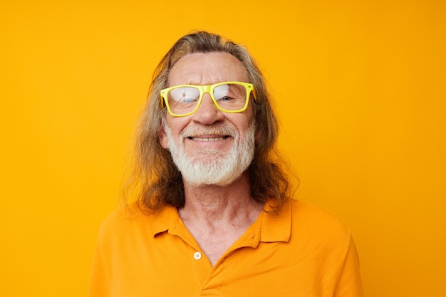 Senior greyhaired man in yellow glasses with a gray beard emotions isolated background