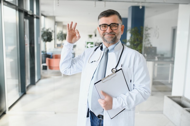 Senior in a hall Doctor in a uniform Man in a glasses