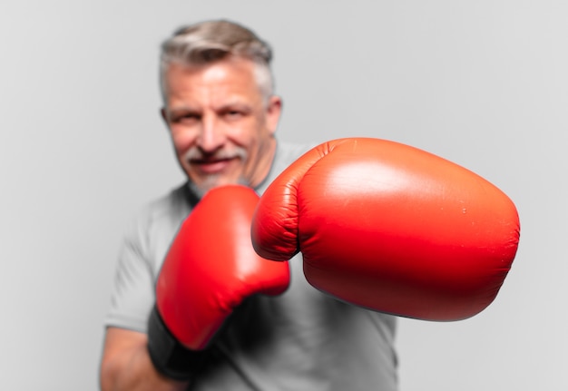 Senior handsome man boxing