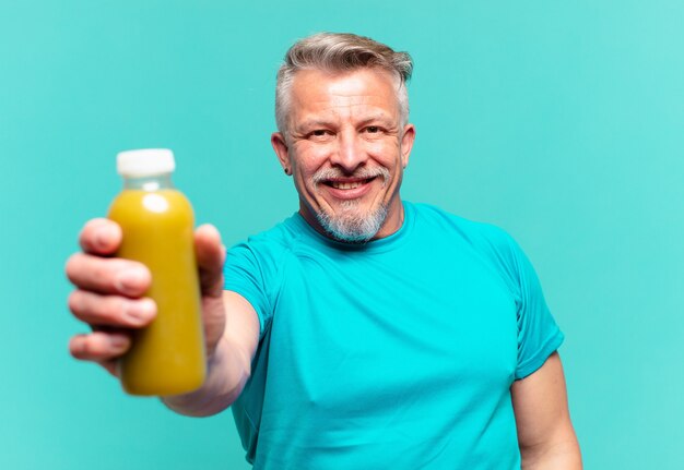 Senior handsome man drinking a vegan smoothy