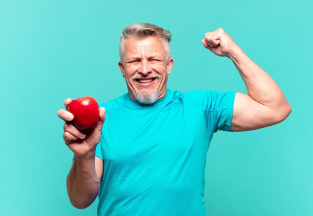 Senior handsome man with an apple