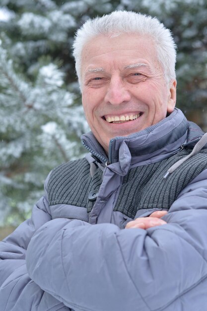 Senior happy man posing outdoors in winter