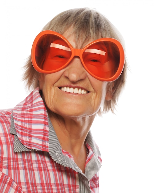 Senior happy woman wearing big sunglasses doing funky action