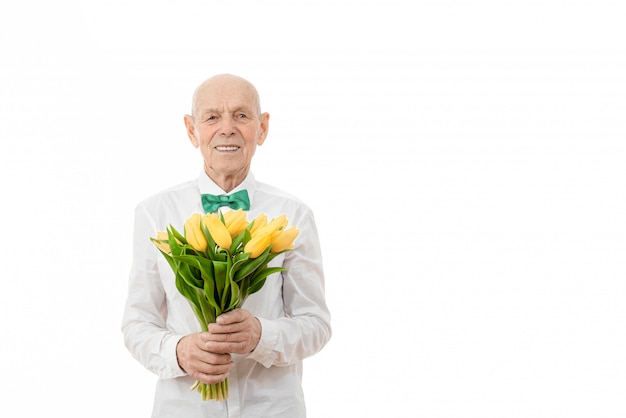 Senior houdt boeket gele bloemen in handen