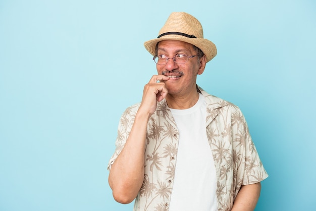 Senior indian man wearing summer clothes isolated on blue background