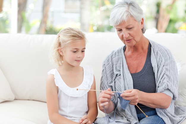 Senior knitting with her granddaughter