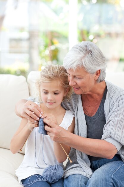 Senior knitting with her granddaughter