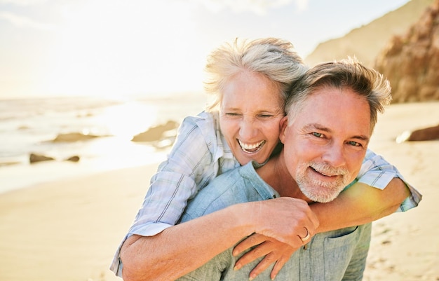 Senior koppel strand en meeliften portret met glimlach samen zomer en wandeling voor geheugen komische tijd of zorg Oudere man oude vrouw of knuffel voor grappig moment buiten of zonneschijn door golven met liefde