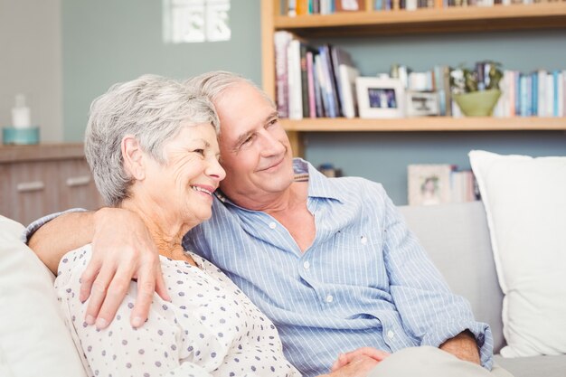 senior koppel zittend op de bank thuis