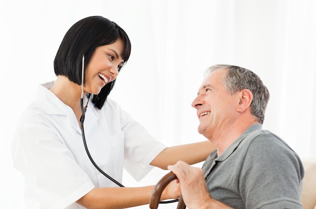 Senior laughing with his nurse